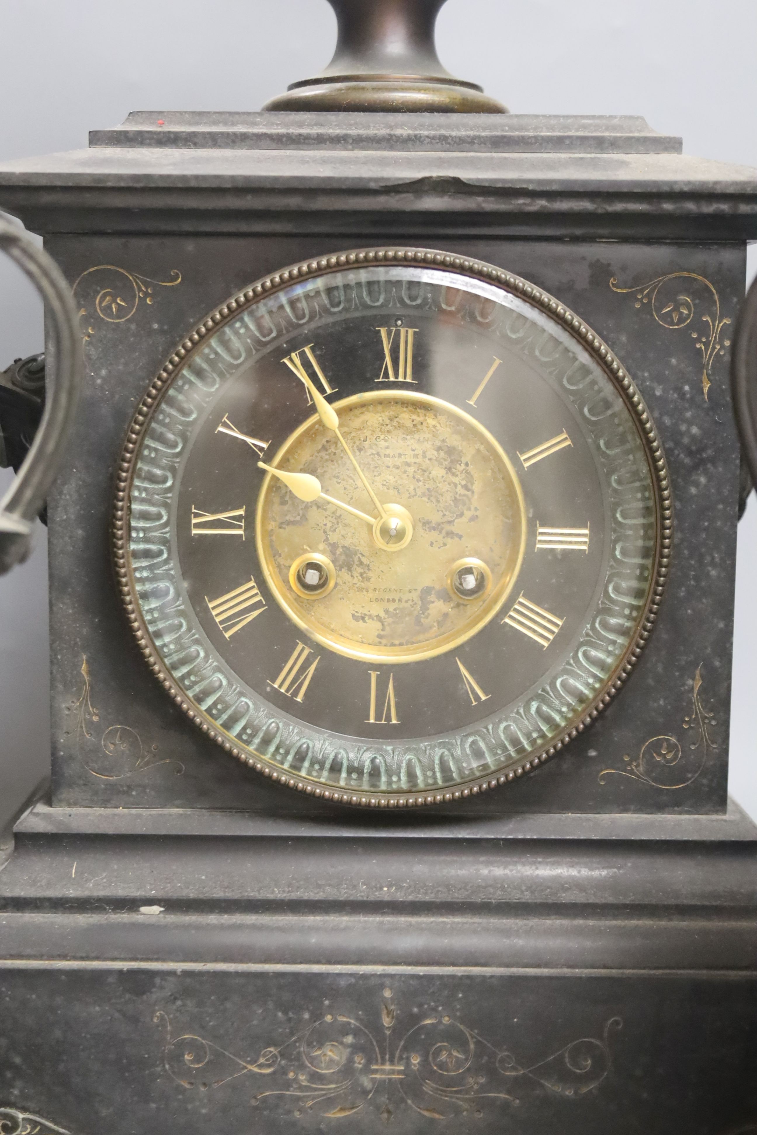 A Victorian black marble and bronze three piece clock garniture. Key and pendulum. 54cm